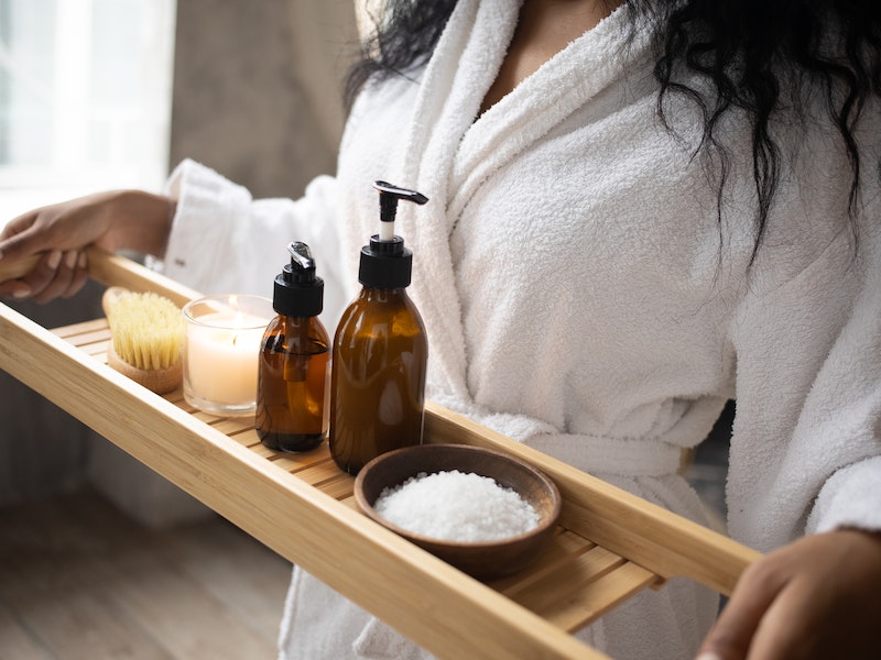 A women carrying a Set of products for skincare on bathtub